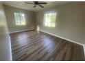 Bright bedroom featuring new floors and two large windows providing ample natural light at 1727 Bonita Ave, Orlando, FL 32805