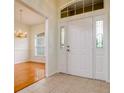 Bright foyer featuring tiled floor, high ceilings, and a glimpse into the dining room at 2214 Deerbrook Dr, Lakeland, FL 33811