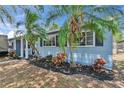 Charming exterior detail with manicured landscaping and healthy mature palms at 750 Azalea Dr, Bartow, FL 33830