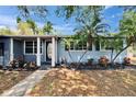 Inviting front entry with decorative door, landscaping, and freshly painted trim at 750 Azalea Dr, Bartow, FL 33830