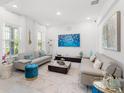 Bright living room features neutral furniture, stylish décor, and plenty of natural light at 921 Fieldstone Way, Haines City, FL 33844
