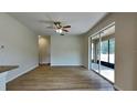 Spacious living room with hardwood floors and glass sliding door at 3002 Sunscape Ter, Groveland, FL 34736