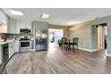 Modern kitchen with stainless steel appliances, sleek cabinets, and an adjacent dining area at 781 Little Pine Dr, South Daytona, FL 32119
