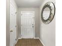 Inviting foyer featuring tile flooring, a mirror, and a white front door at 358 Canna Dr, Davenport, FL 33897