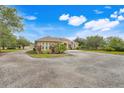 Stunning single-story home with a two-car garage, mature landscaping, archway entrance and gravel driveway on an expansive lot at 3979 Mammoth Grove Rd, Lake Wales, FL 33898