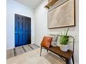 Inviting entryway with bench seating, decorative rug, and stylish wall art at 8830 Fox Dr, Polk City, FL 33868