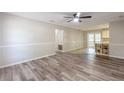 Open living room with wood flooring, connecting to the dining area and kitchen, creates an inviting atmosphere at 5926 N Fork Ct, Lakeland, FL 33809