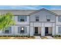 Charming townhome with neutral paint, blue shutters, and a well-kept lawn at 7614 Oak Spring Ln, Davenport, FL 33837