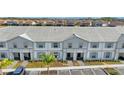 Townhome community offers well-maintained exteriors and convenient parking for residents and guests at 7614 Oak Spring Ln, Davenport, FL 33837