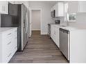Beautiful kitchen with stainless steel appliances, white cabinets, and modern wood flooring at 2680 Sw 144 Ct, Ocala, FL 34481