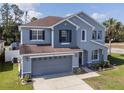 Two-story blue home with a spacious front yard and attached two-car garage at 3125 Kearns Rd, Mulberry, FL 33860