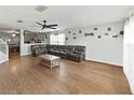 Inviting living room featuring hardwood floors, modern ceiling fan, and a comfortable sectional sofa at 3125 Kearns Rd, Mulberry, FL 33860