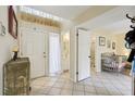 Bright entryway with tile flooring, white doors, and a view into an adjacent bathroom at 4836 Pebble Beach Dr, Orlando, FL 32811