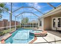 Relaxing screened-in pool and spa with brick accents, offering a private outdoor oasis at 13708 Old Dock Rd, Orlando, FL 32828