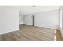 Spacious room featuring wood-look flooring, fresh paint, and updated lighting fixtures at 2791 Citron Dr, Longwood, FL 32779