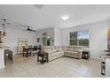 Bright living space with tile flooring, dining area, large sectional sofa and a sliding glass door at 3550 Rodrick Cir, Orlando, FL 32824