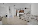 Open-concept living room with tile floors, staircase, comfortable seating and easy access to the kitchen at 3550 Rodrick Cir, Orlando, FL 32824