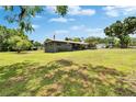 Sprawling front and side yard, featuring a well-maintained lawn and mature trees in a tranquil setting at 4145 Willow Oak Rd, Mulberry, FL 33860
