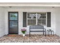Welcoming front porch with brick flooring, bench seating, and a charming entryway at 455 W Plumosa St, Bartow, FL 33830