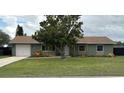 Inviting home with a well-manicured lawn and mature tree providing shade in the front yard at 4727 Wales St, Lake Wales, FL 33859