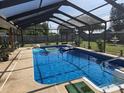 Sparkling in-ground pool enclosed by a screened lanai, perfect for relaxing and entertaining outdoors at 4727 Wales St, Lake Wales, FL 33859