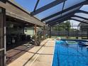 Spacious pool area with a covered patio, outdoor kitchen, and ample seating for entertaining guests at 4727 Wales St, Lake Wales, FL 33859