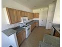 Spacious kitchen with tile floors, wooden cabinetry, and a full suite of appliances at 6354 Sedgeford Dr, Lakeland, FL 33811