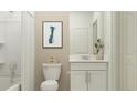 Cozy bathroom featuring a white vanity and toilet with a bathtub at 1181 Hour Glass Rd, Lakeland, FL 33801