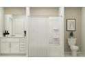 Neutral bathroom with white vanity, bathtub/shower combo and decorative accents at 1181 Hour Glass Rd, Lakeland, FL 33801