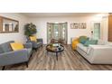 Sun-filled living room with hardwood floors and elegant decor, perfect for relaxation at 1820 N Merrick Dr, Deltona, FL 32738