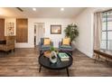 Comfortable living room showcasing hardwood floors, with an open flow to kitchen and dining areas at 1820 N Merrick Dr, Deltona, FL 32738