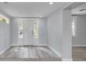 Bright entryway featuring stylish wood-look flooring and a welcoming white door at 110 E Lauren Ct, Fern Park, FL 32730