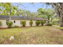 Picture of the house showing the front side, with green lawn and trees at 110 E Lauren Ct, Fern Park, FL 32730