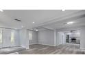 Open-concept living space with stylish flooring, recessed lighting and neutral gray walls at 110 E Lauren Ct, Fern Park, FL 32730