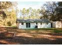 View of the backyard with storage shed, green patio pad and a garden at 20732 Sw Marine Blvd, Dunnellon, FL 34431