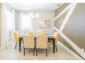 Dining area with stylish accent wall, chandelier, and seating for four at 5884 Meditation Dr, Clermont, FL 34714