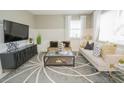 Comfortable living room with plush seating, modern decor, and a decorative rug at 5884 Meditation Dr, Clermont, FL 34714