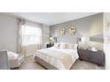 Inviting bedroom with a large window, plush bedding, and stylish decor at 7656 Gemstone St, Groveland, FL 34736