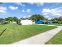 The home's exterior view showcases a vast lawn and an outside view of neighboring homes at 4821 S Gachet Blvd, Lakeland, FL 33813