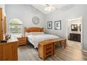 Cozy bedroom showcasing wood furniture, lots of natural light, modern ceiling fan and ensuite bath at 25302 Lido Ave, Sorrento, FL 32776