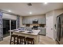Bright kitchen with stainless steel appliances, a center island, and a door to the outside at 1748 Frogmore Ave, Haines City, FL 33844