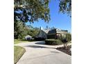 Exterior view of home featuring a side driveway, detached garage and mature landscaping at 2528 Deerbrook Dr, Lakeland, FL 33811
