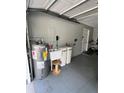 View of the garage with water tanks and a utility sink, providing functionality at 2528 Deerbrook Dr, Lakeland, FL 33811