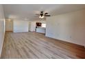 Bright, open-concept living room with laminate flooring, ceiling fan, and natural light at 4601 Glencrest Loop, St Cloud, FL 34772