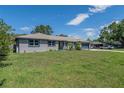 Attractive gray home with a well-manicured front yard and a beautiful front garden at 1416 Leighton Ave, Lakeland, FL 33803