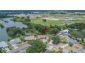 Aerial view of home showing a spacious lot, nearby lake, and proximity to amenities and attractions at 1716 Bayou Cir, Lakeland, FL 33803