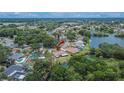 Aerial view showing this home's peaceful, lush neighborhood with multiple ponds and mature trees at 1716 Bayou Cir, Lakeland, FL 33803