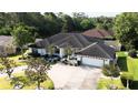 Aerial view of a beautiful home featuring a landscaped yard and an attached two-car garage at 2418 Se 23Rd St, Ocala, FL 34471