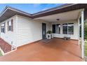 Covered outdoor area with painted flooring, offering a cozy spot with a view of the surrounding neighborhood at 4846 Colonnades Club Blvd, Lakeland, FL 33811