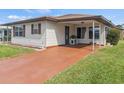 Well-kept single-story home showing a painted driveway, low-maintenance yard, and covered entryway at 4846 Colonnades Club Blvd, Lakeland, FL 33811
